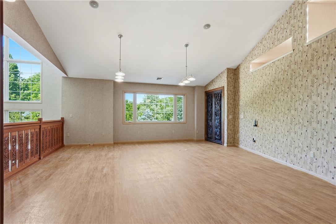 6271 Batman Road Zionsville, PA 18092 - Photo 65 of 100 Natural light floods this versatile living area, boasting a vaulted ceiling and rich wood flooring.