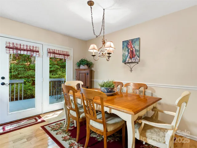 a view of a dining room with furniture wooden floor and a chandelier