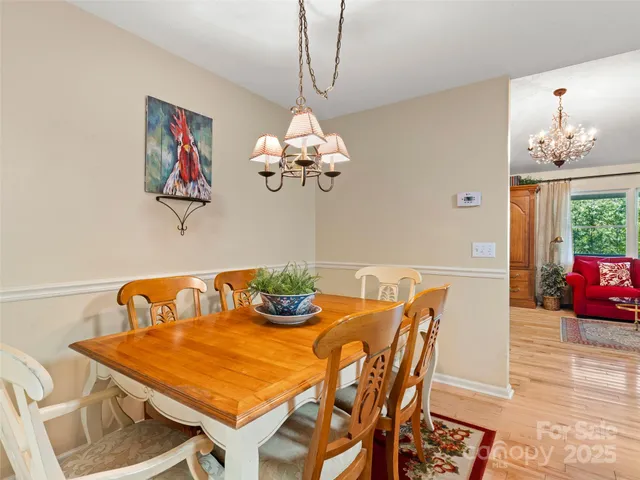 a dining room with furniture and chandelier
