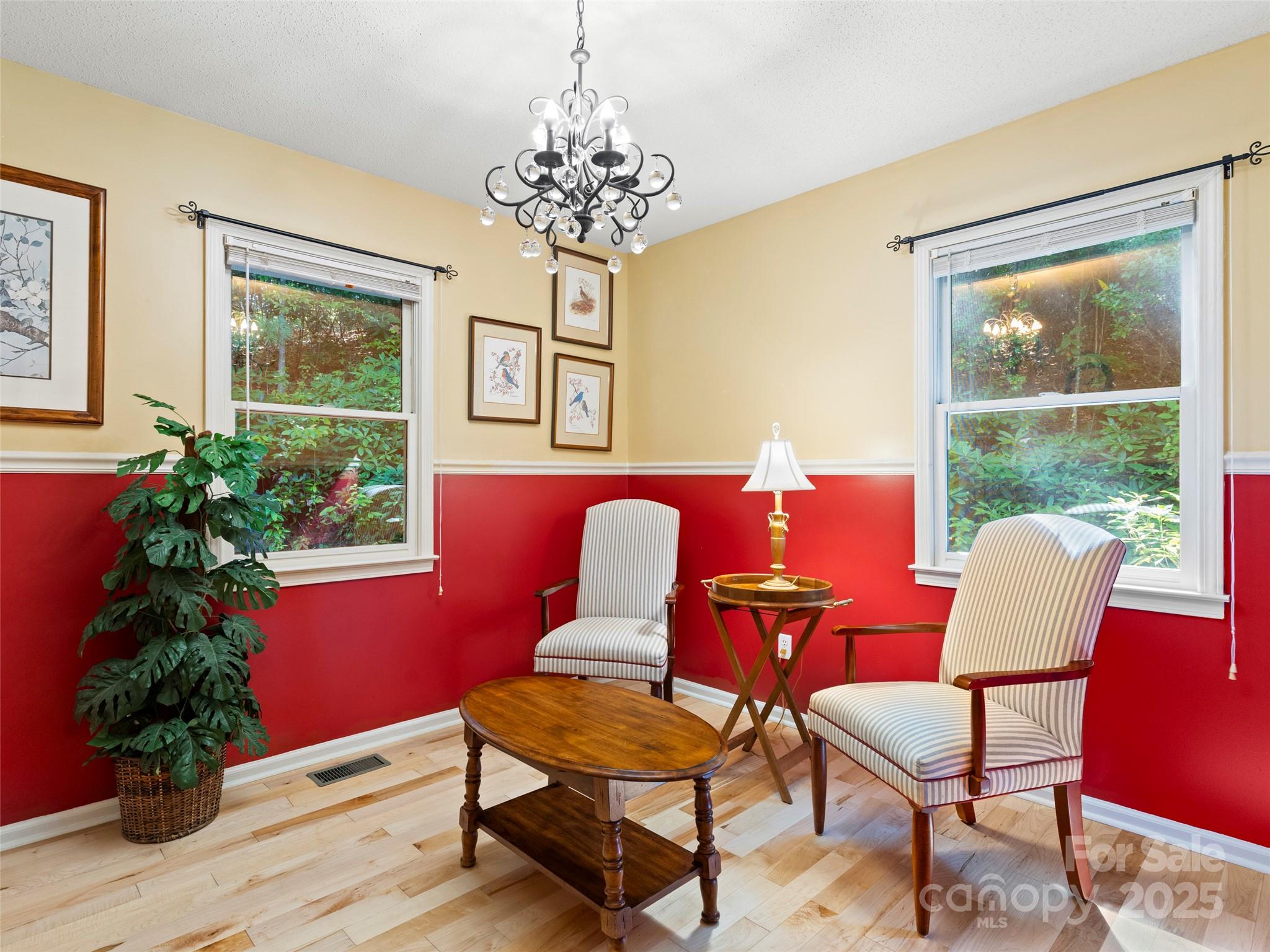 296 Ivy Ridge Circle Sylva, NC 28779 - Photo 14 of 42 a view of a dining room with furniture a chandelier and wooden floor