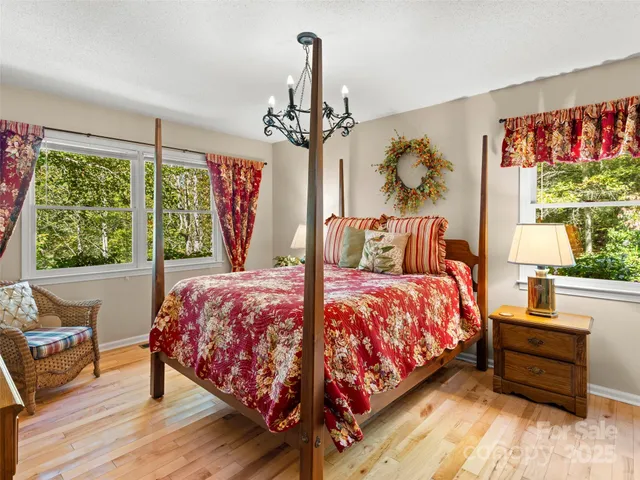 a bedroom with a bed a dresser next to a window