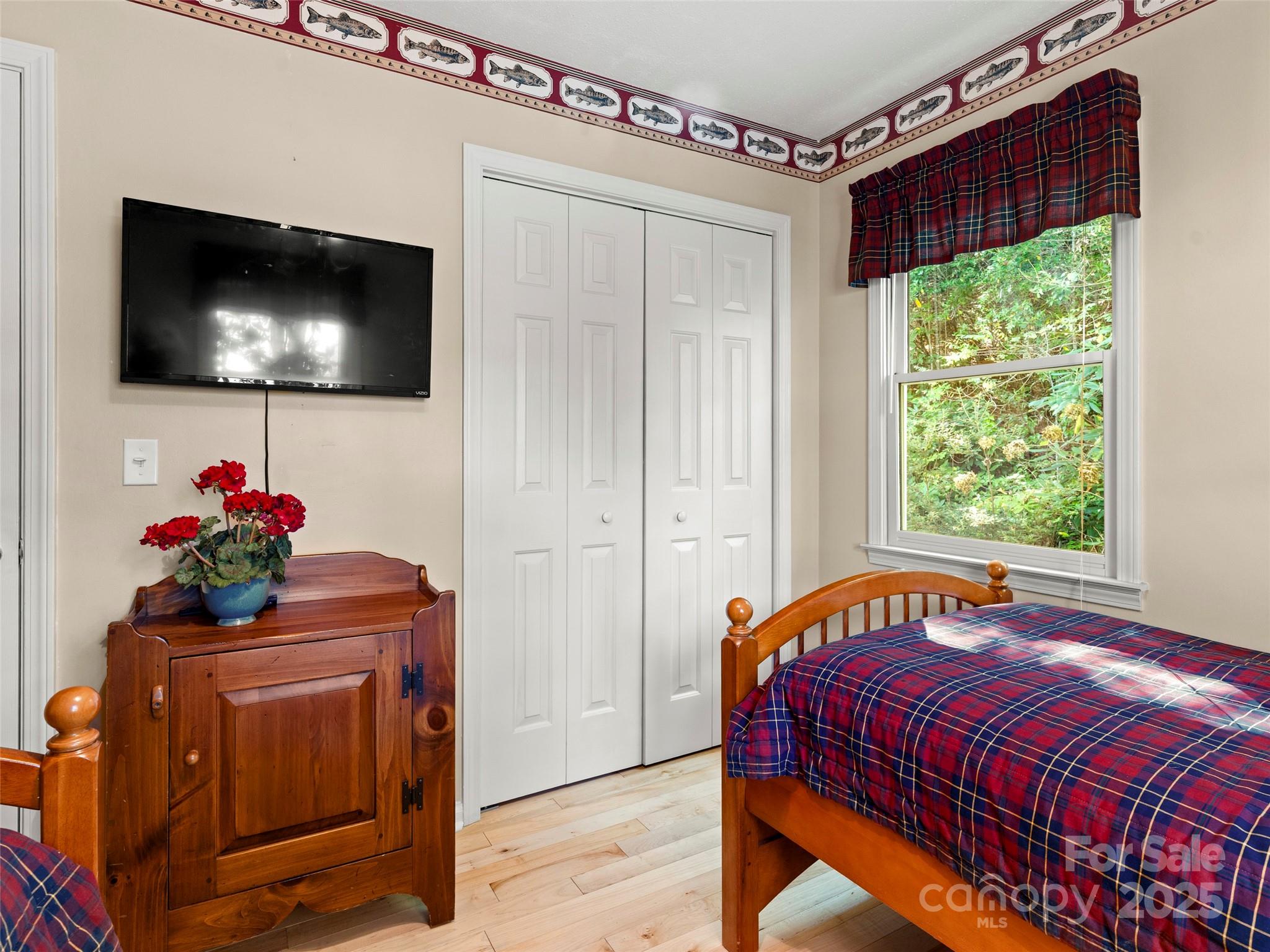 296 Ivy Ridge Circle Sylva, NC 28779 - Photo 22 of 42 a bedroom with a bed and a flat screen tv