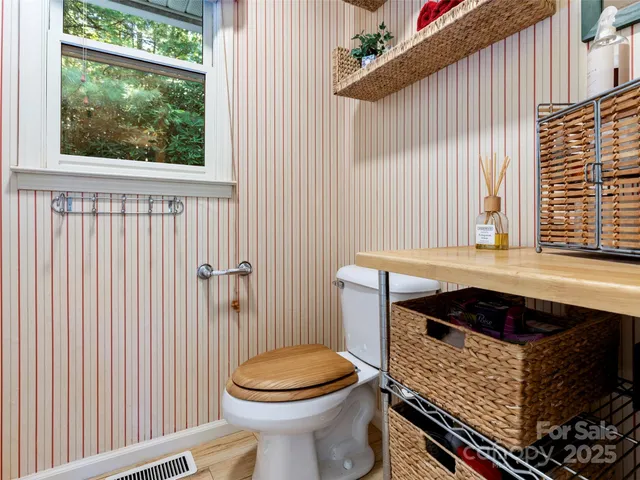 a bathroom with a toilet a sink and a window