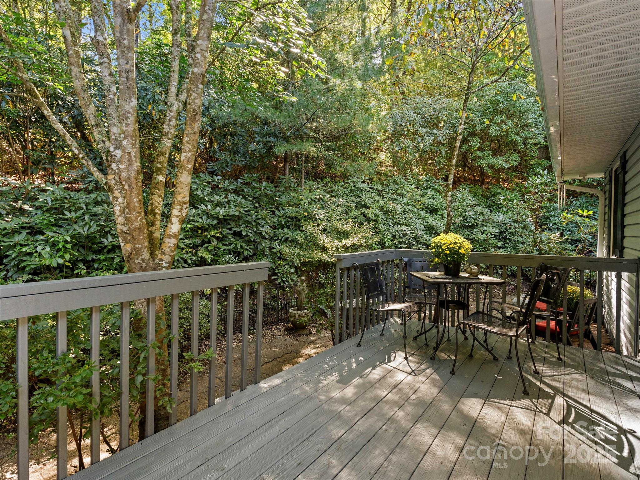 296 Ivy Ridge Circle Sylva, NC 28779 - Photo 27 of 42 a view of two chairs and table on the wooden deck