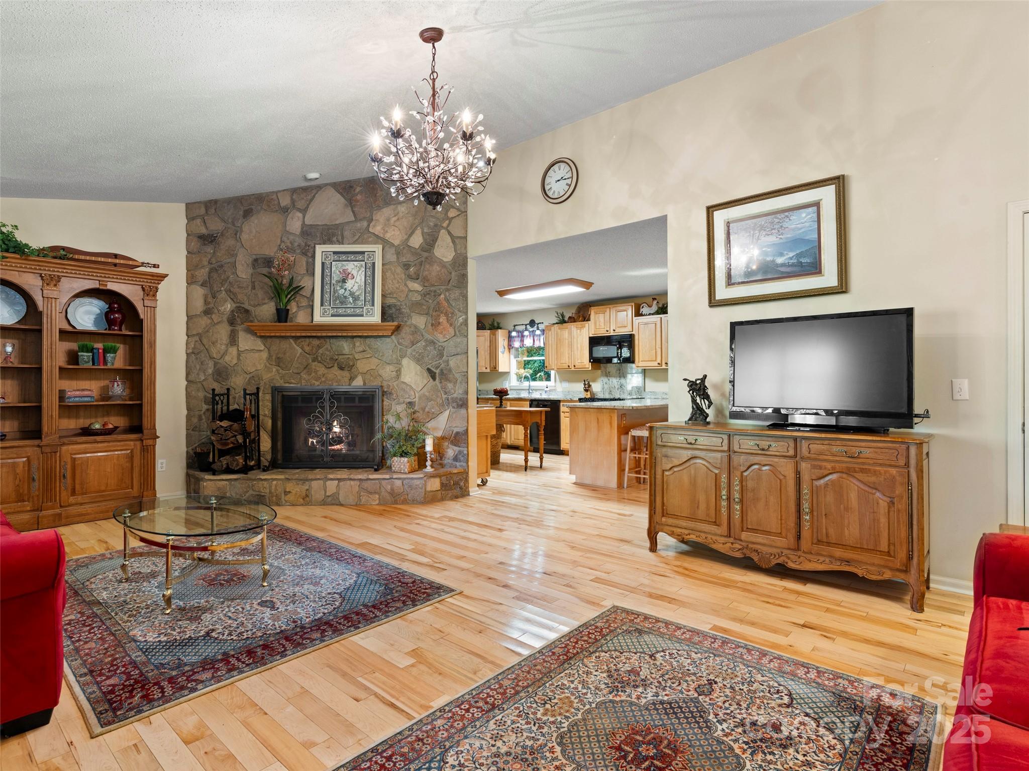 296 Ivy Ridge Circle Sylva, NC 28779 - Photo 6 of 42 a living room with furniture a flat screen tv and kitchen view