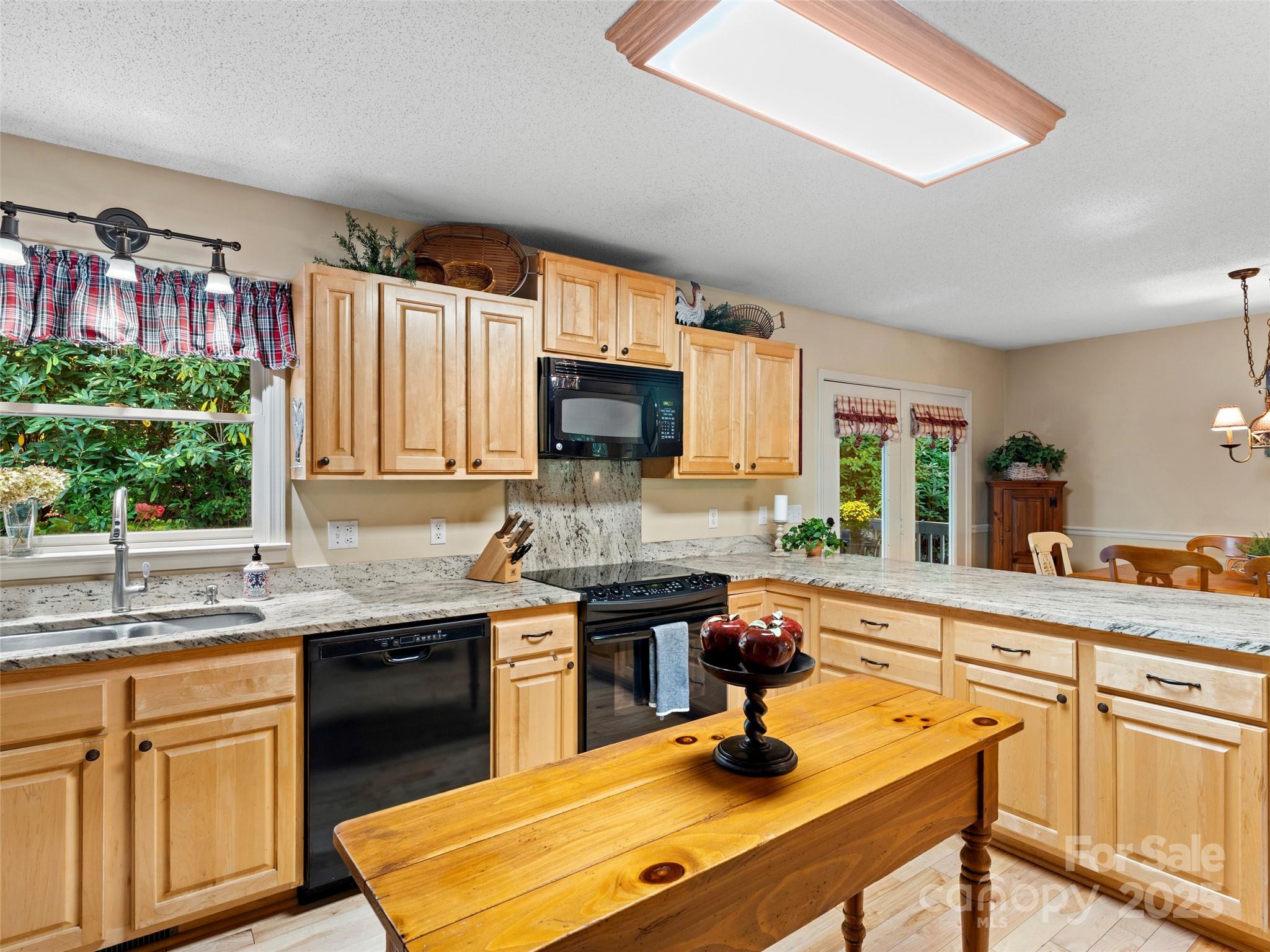 296 Ivy Ridge Circle Sylva, NC 28779 - Photo 9 of 42 a kitchen with a sink stove and microwave