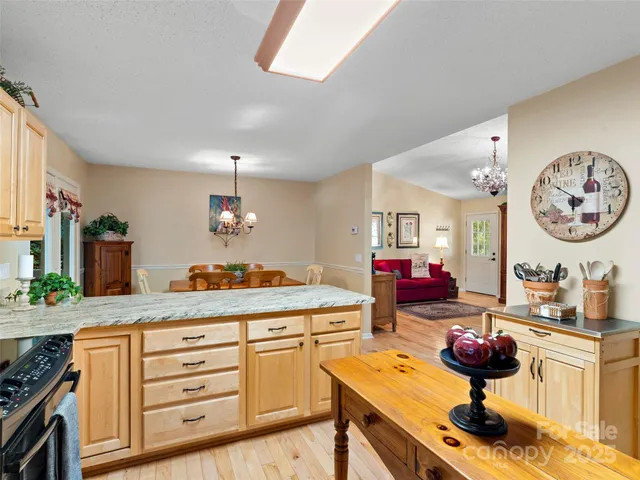 a very nice looking kitchen with a stove and a white cabinets