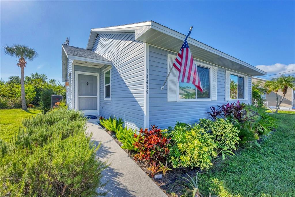 a view of a house with potted plants