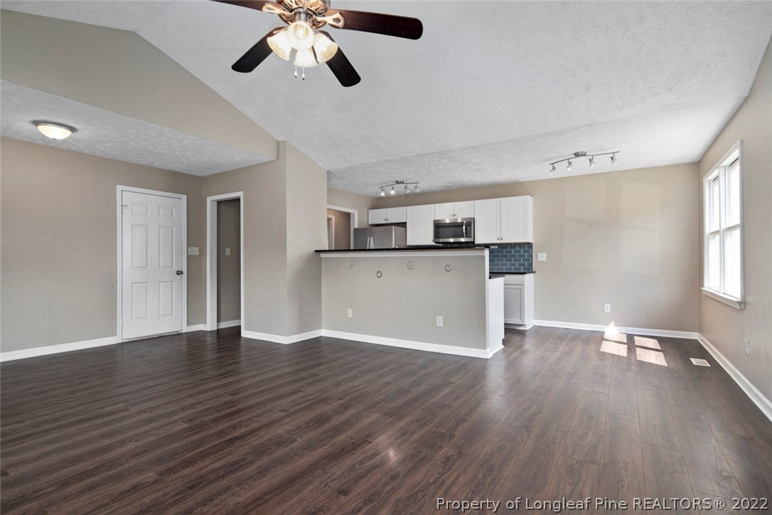 6573 Applewhite Road Fayetteville, NC 28304 - Photo 11 of 35 a view of a kitchen with a dishwasher cabinets and wooden floor