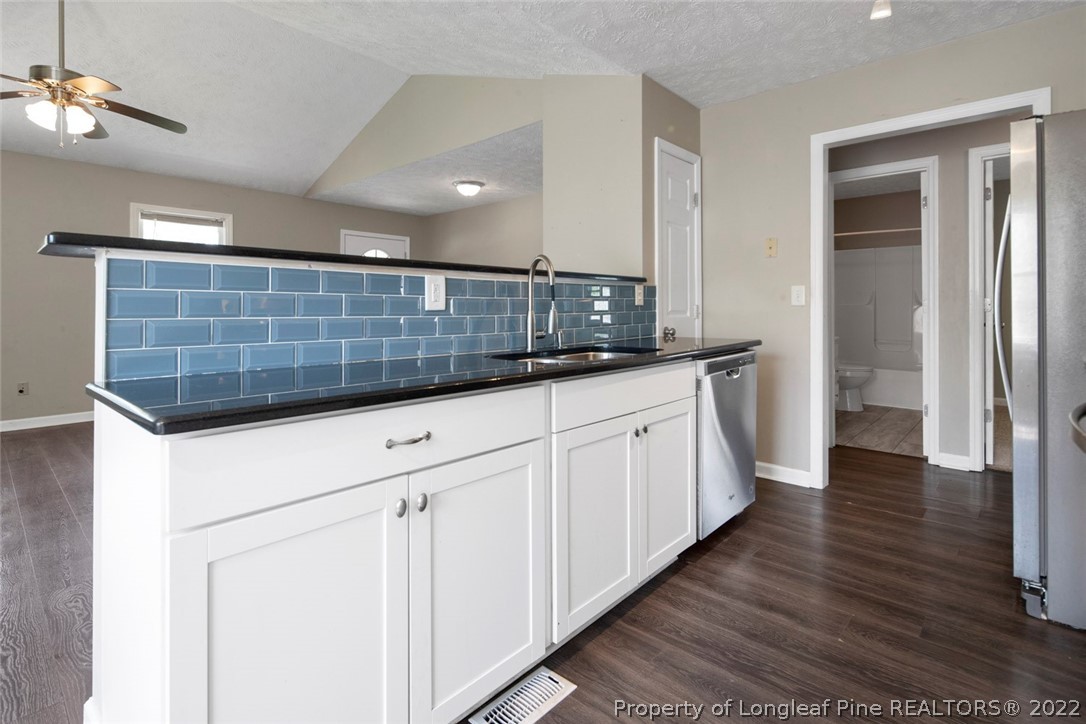 6573 Applewhite Road Fayetteville, NC 28304 - Photo 14 of 35 a kitchen with granite countertop white cabinets and white appliances