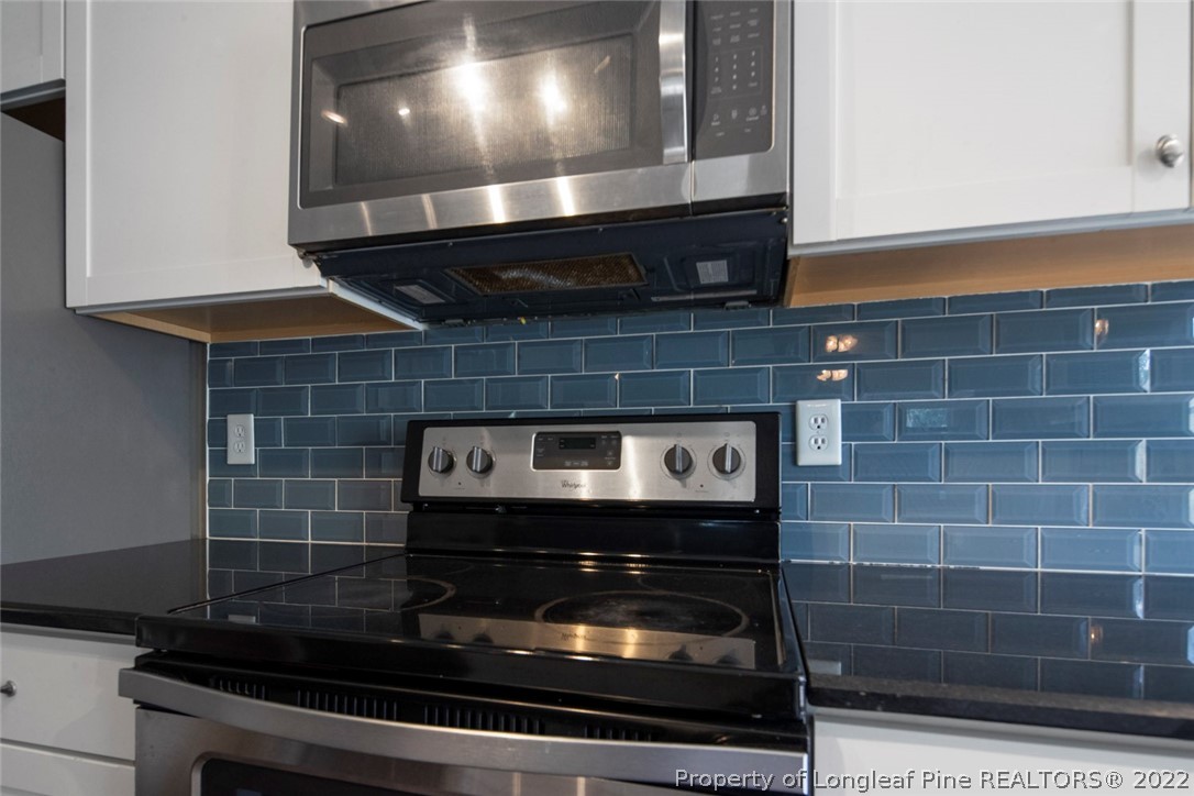 6573 Applewhite Road Fayetteville, NC 28304 - Photo 17 of 35 a stove top oven sitting inside of a kitchen