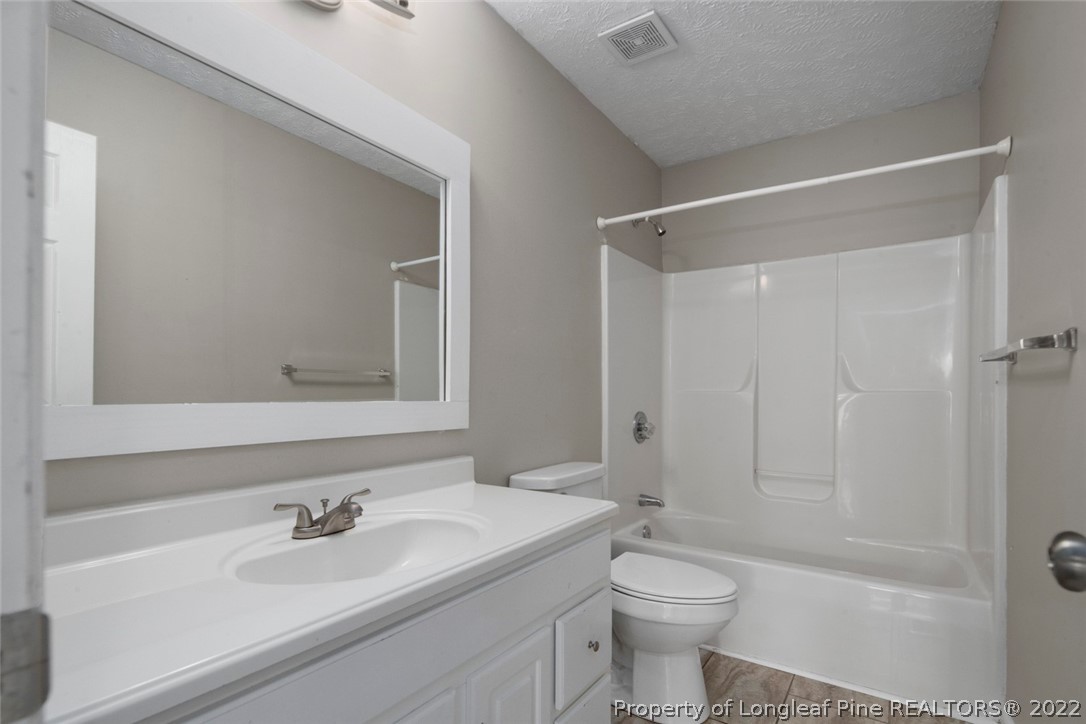 6573 Applewhite Road Fayetteville, NC 28304 - Photo 20 of 35 a bathroom with a sink a toilet and shower