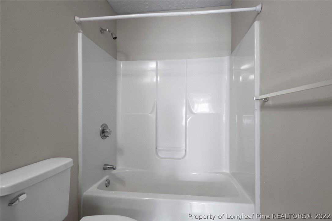 6573 Applewhite Road Fayetteville, NC 28304 - Photo 21 of 35 a bathroom with a glass shower door