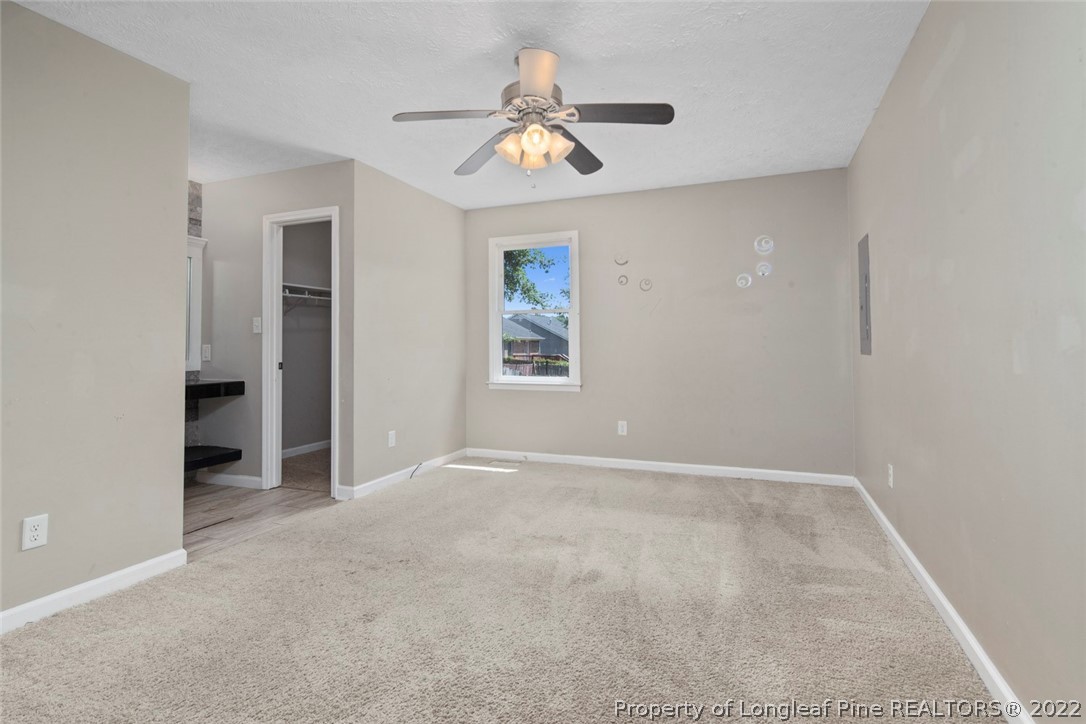6573 Applewhite Road Fayetteville, NC 28304 - Photo 27 of 35 an empty room with windows and a ceiling fan