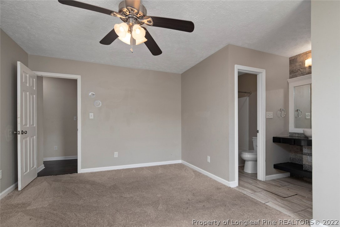 6573 Applewhite Road Fayetteville, NC 28304 - Photo 28 of 35 an empty room and chandelier fan in kitchen