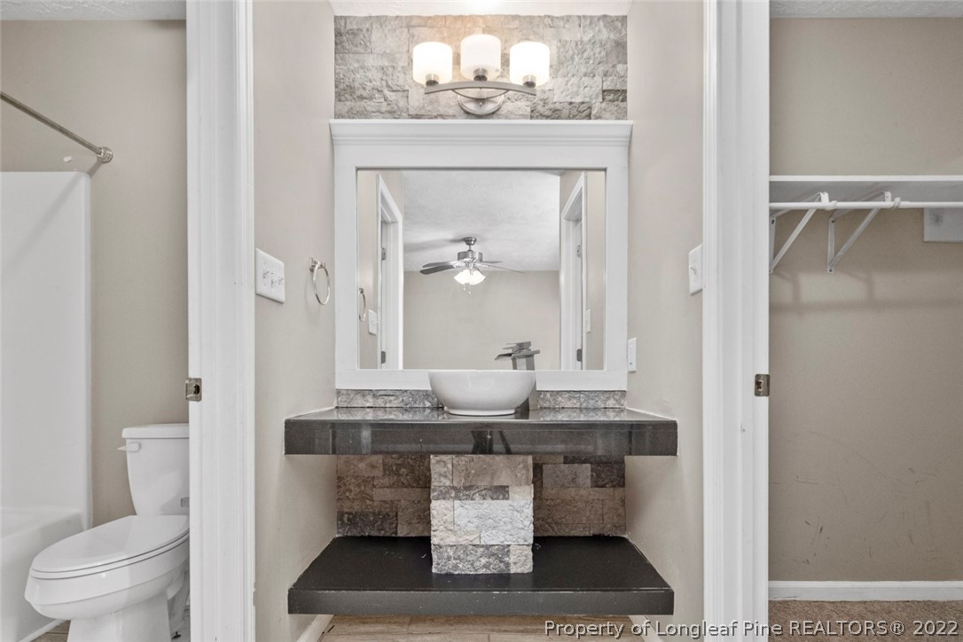 6573 Applewhite Road Fayetteville, NC 28304 - Photo 30 of 35 a bathroom with a sink and a mirror with toilet