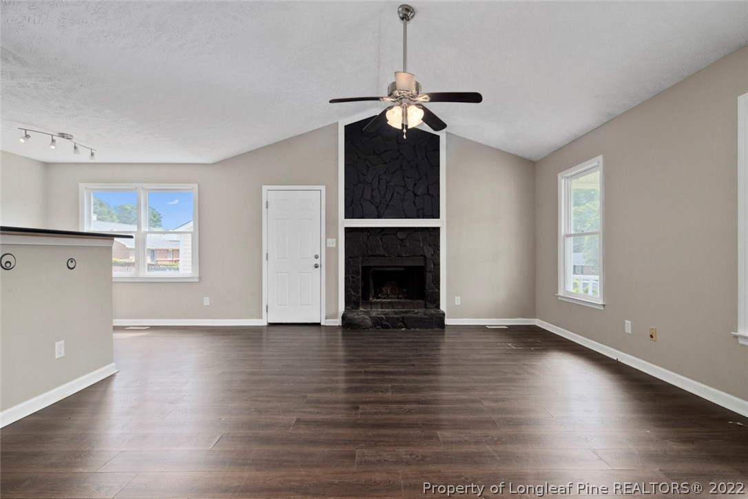 6573 Applewhite Road Fayetteville, NC 28304 - Photo 8 of 35 a view of empty room with wooden floor and fireplace