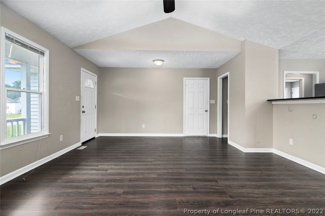 6573 Applewhite Road Fayetteville, NC 28304 - Photo 9 of 35 wooden floor in an empty room with a window