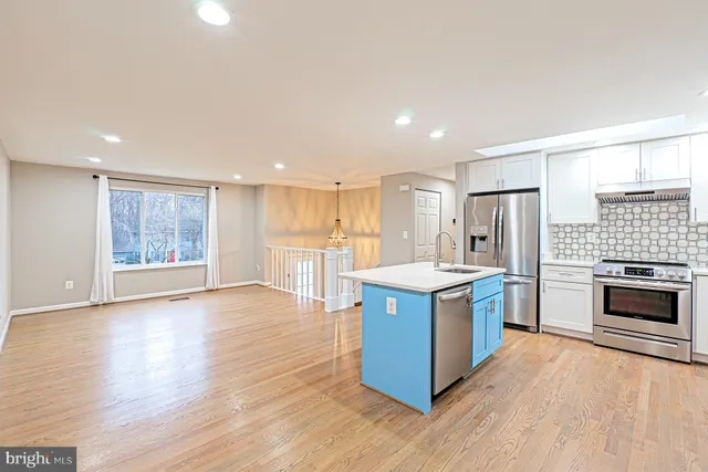 a kitchen with stainless steel appliances granite countertop a stove top oven and cabinets