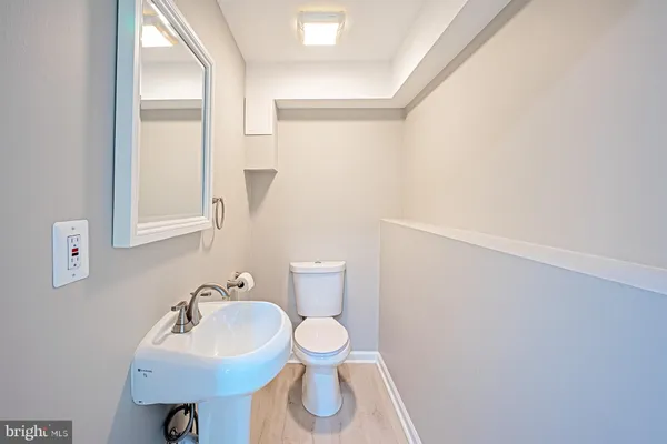 a bathroom with a sink toilet and a mirror