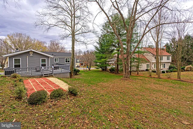 a front view of house with yard and trees