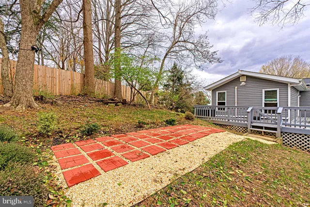 a backyard of a house with barbeque oven