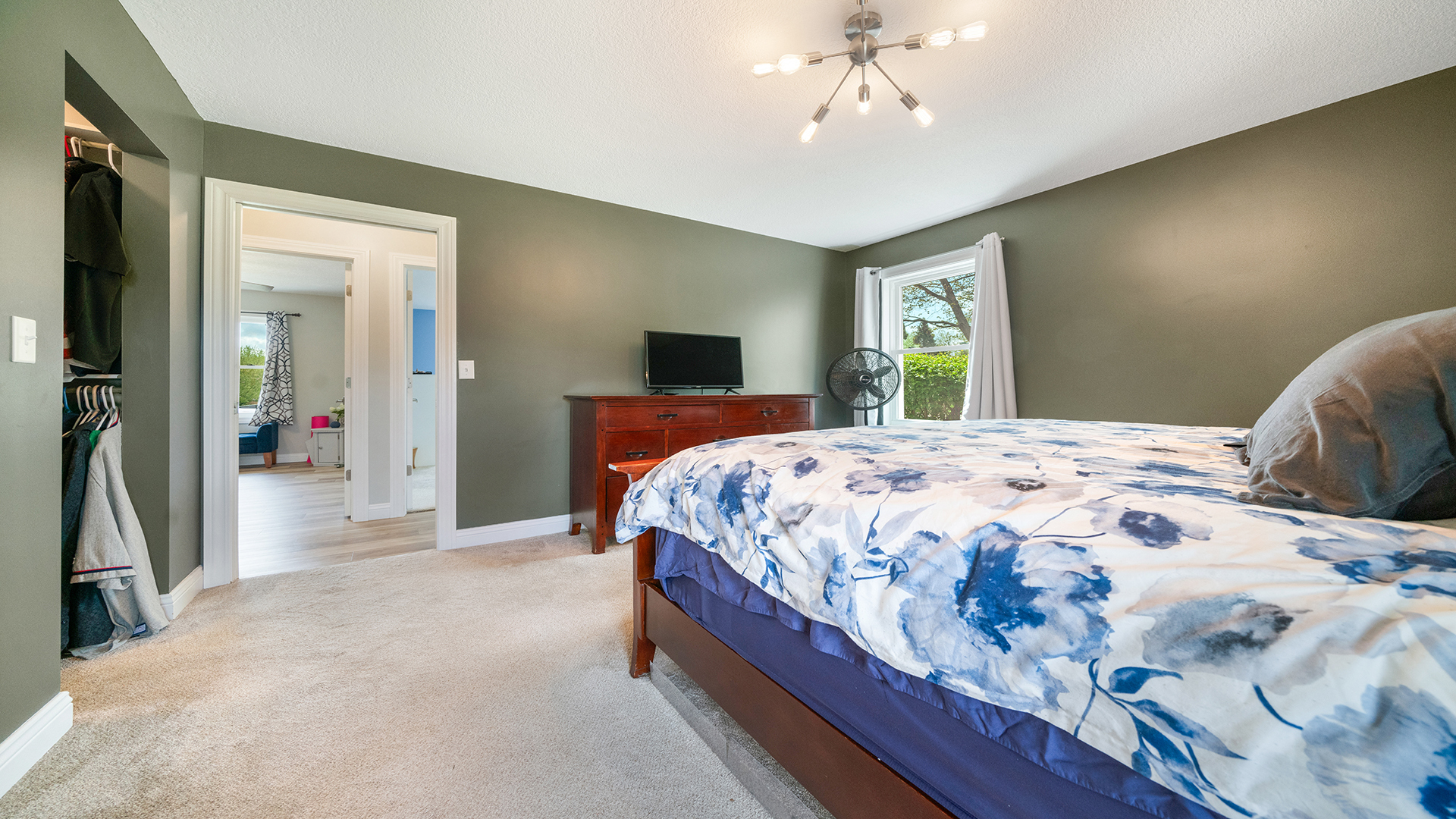 401 Deer Chase Dixon, IL 61021 - Photo 16 of 39 a bedroom with a large bed and a chandelier