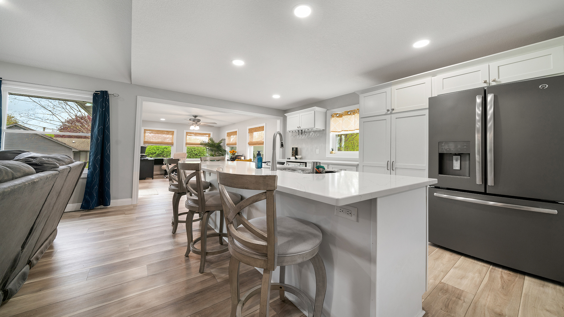 401 Deer Chase Dixon, IL 61021 - Photo 4 of 39 a kitchen with stainless steel appliances kitchen island granite countertop a table chairs refrigerator and sink