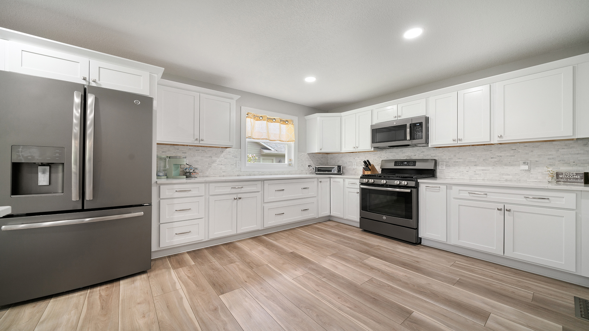 401 Deer Chase Dixon, IL 61021 - Photo 6 of 39 a kitchen with granite countertop white cabinets and stainless steel appliances