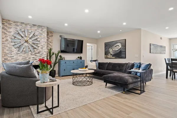 a living room with furniture potted plant and a flat screen tv