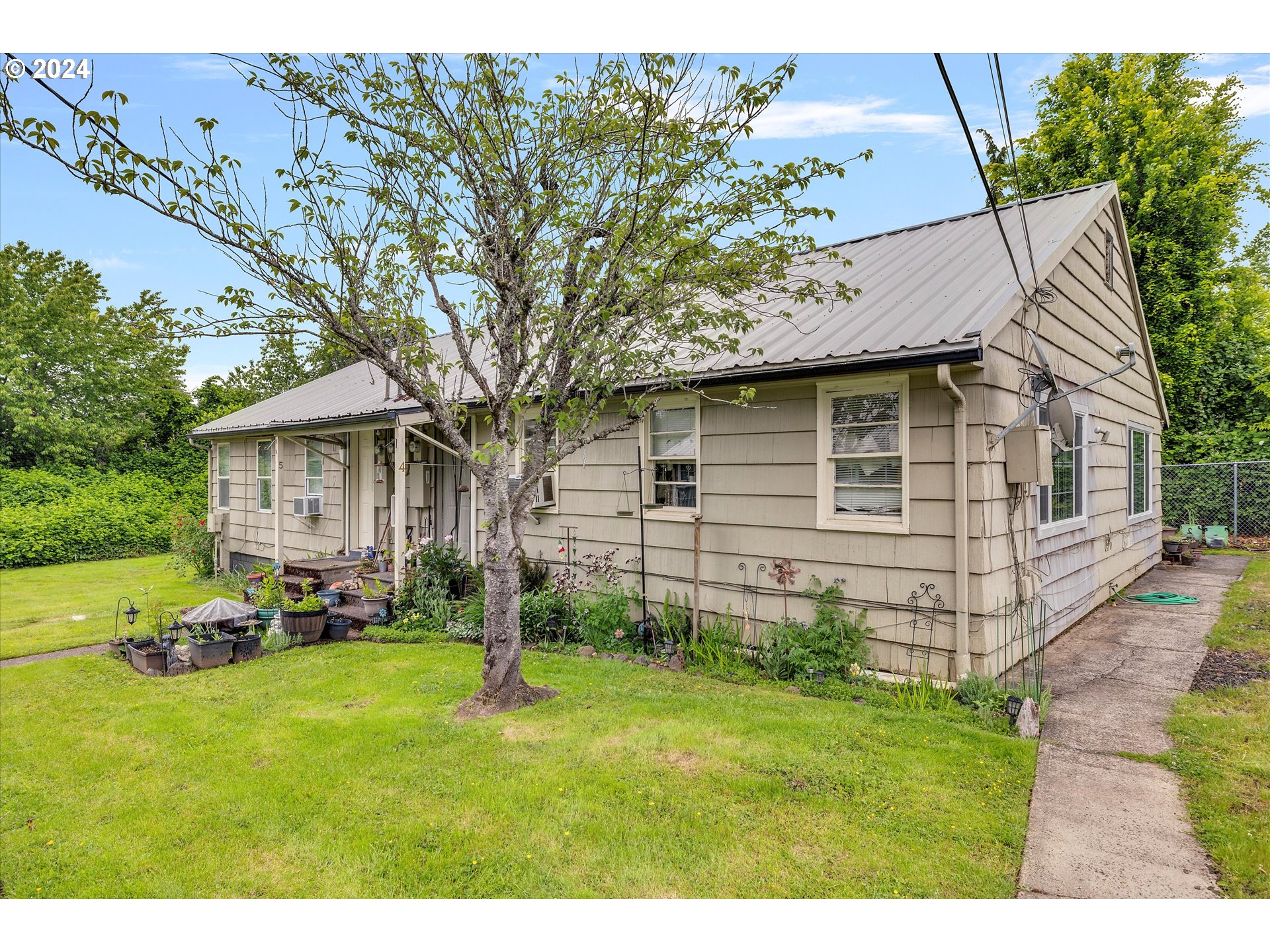 30021 Southeast Orient Drive Gresham, OR 97080 - Photo 11 of 27 a view of a backyard with table and chairs and a large tree