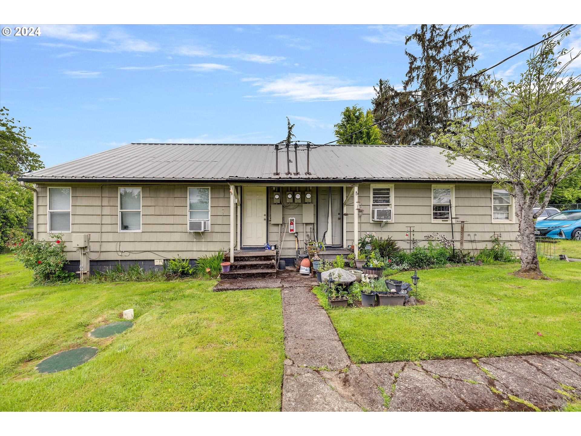 30021 Southeast Orient Drive Gresham, OR 97080 - Photo 12 of 27 a front view of a house with a yard table and chairs