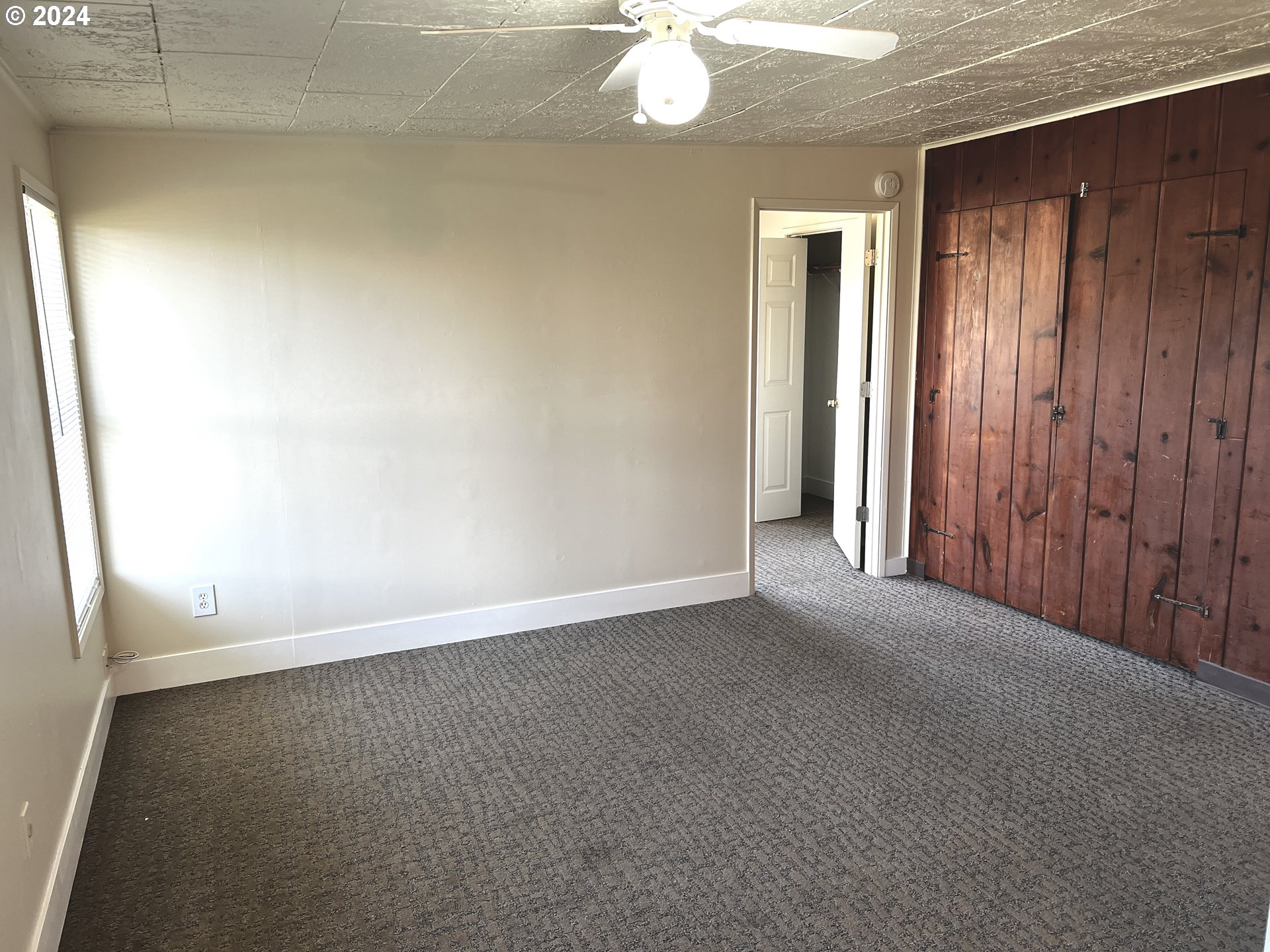 30021 Southeast Orient Drive Gresham, OR 97080 - Photo 24 of 27 an empty room with a chandelier fan and windows
