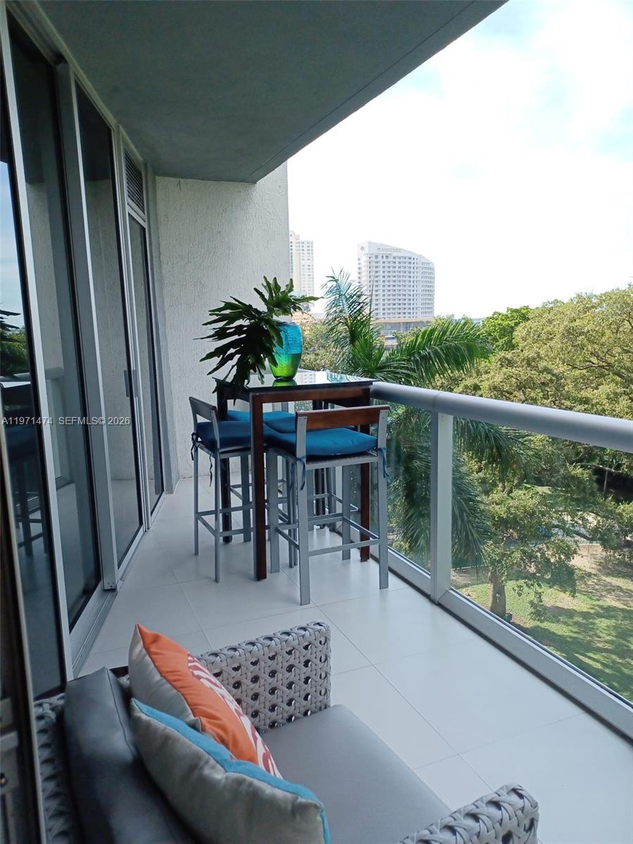 495 Brickell Avenue, Unit 509 Miami, FL 33131 - Photo 16 of 25 a balcony with furniture and a potted plant