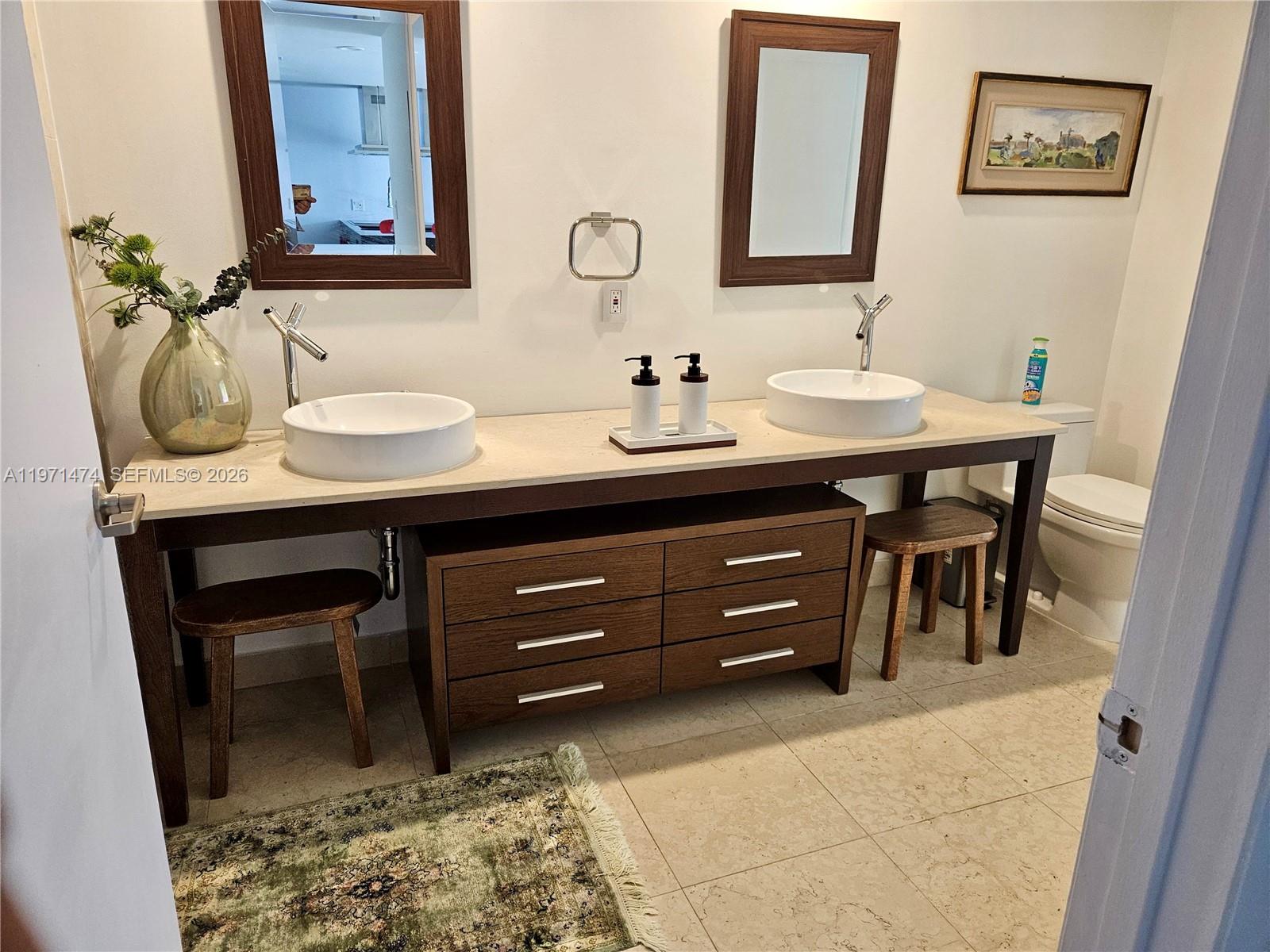 495 Brickell Avenue, Unit 509 Miami, FL 33131 - Photo 6 of 25 a bathroom with a sink and a mirror