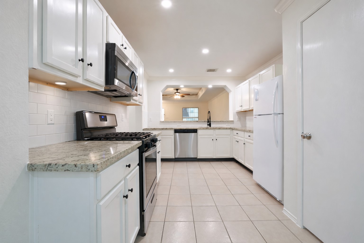 7907 Fire Thorn Lane Cypress, TX 77433 - Photo 6 of 17 a kitchen with stainless steel appliances granite countertop a sink and cabinets