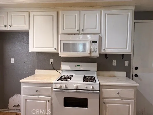 a stove top oven sitting inside of a kitchen