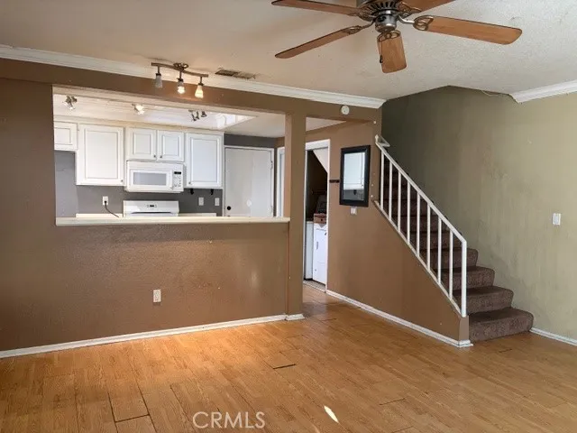 a view of a kitchen with a sink cabinets and staircase