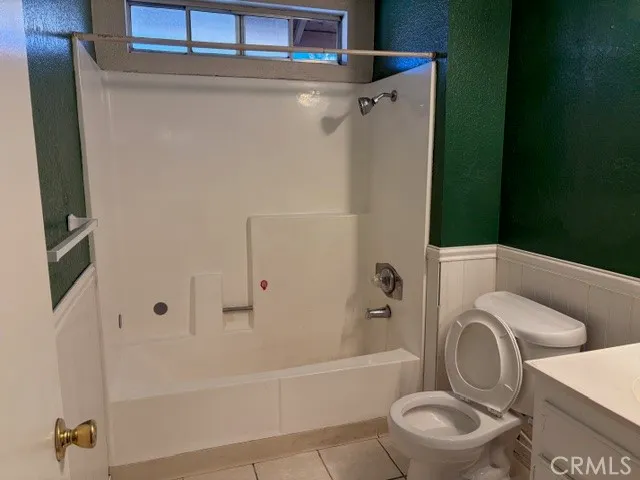 a bathroom with a toilet a sink and bathtub
