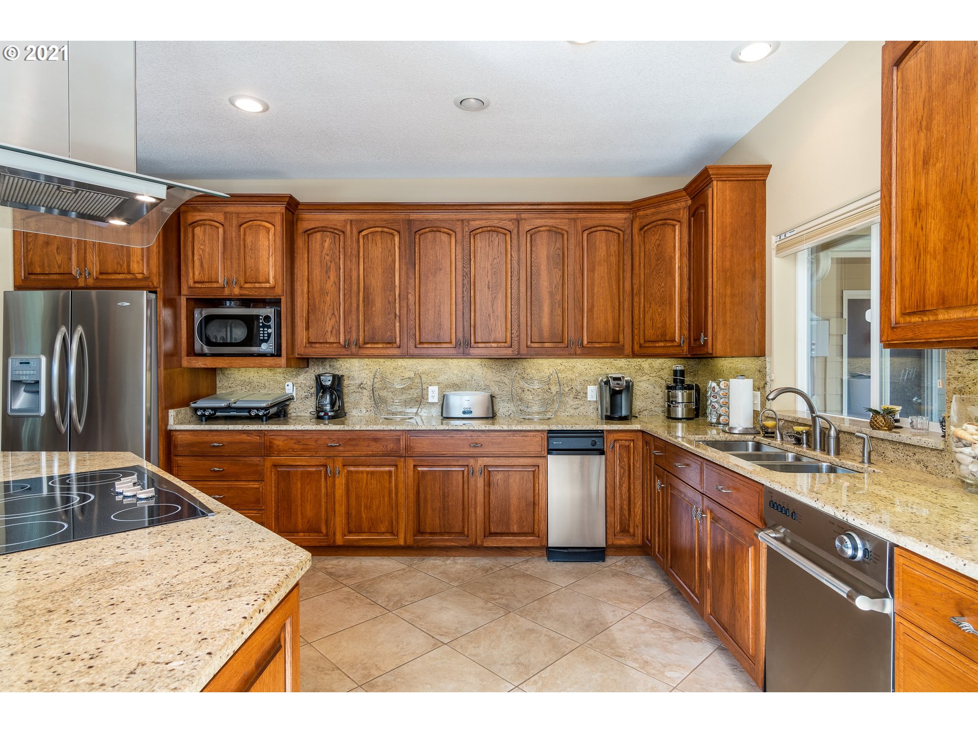 70946 Devore Arm Road Lakeside, OR 97449 - Photo 11 of 48 a kitchen with stainless steel appliances granite countertop a sink dishwasher stove and refrigerator