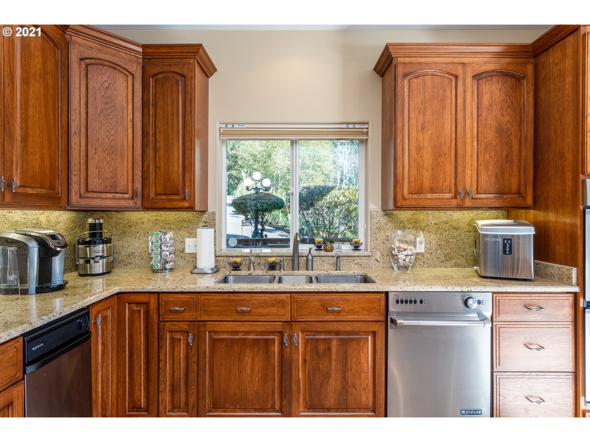 70946 Devore Arm Road Lakeside, OR 97449 - Photo 12 of 48 a kitchen with kitchen island granite countertop a sink window and cabinets