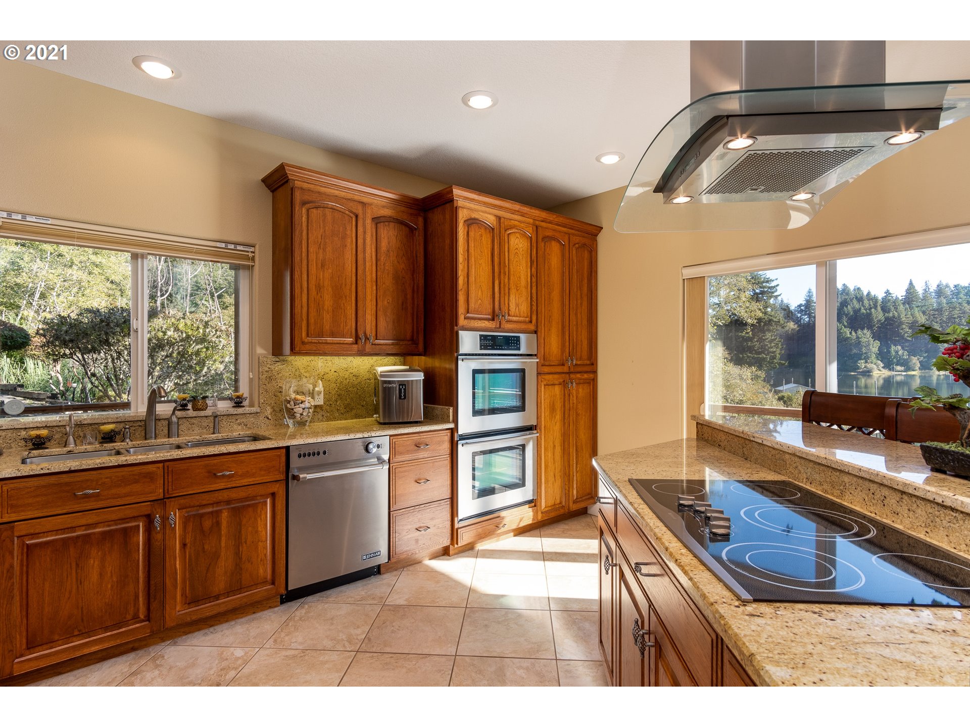 70946 Devore Arm Road Lakeside, OR 97449 - Photo 13 of 48 a kitchen with stainless steel appliances granite countertop a sink and wooden cabinets
