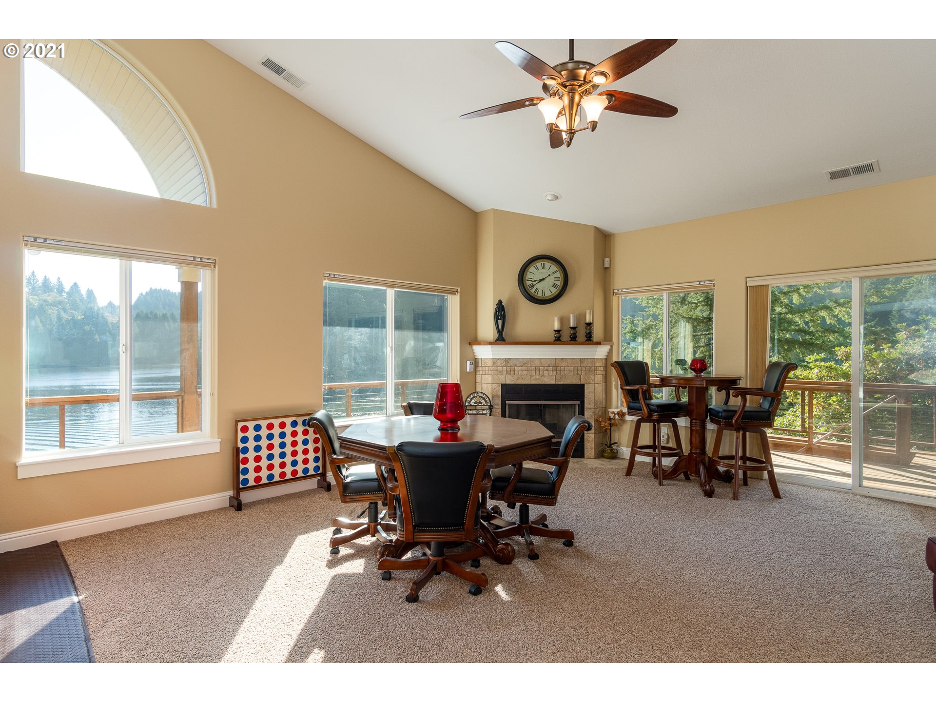 70946 Devore Arm Road Lakeside, OR 97449 - Photo 16 of 48 a living room with furniture a fireplace and a large window