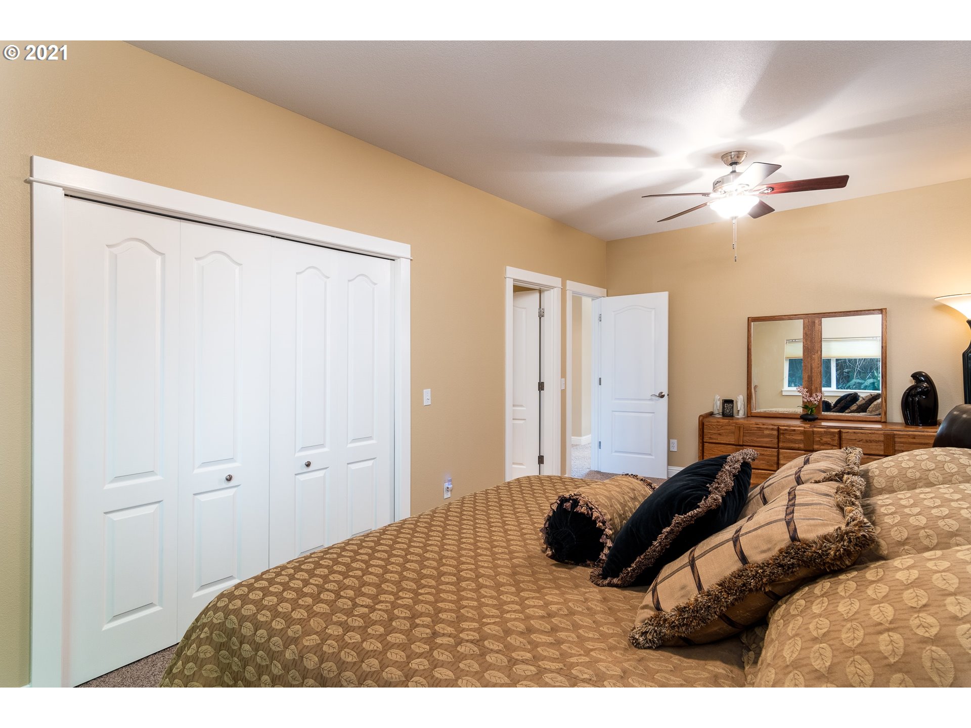 70946 Devore Arm Road Lakeside, OR 97449 - Photo 20 of 48 a bedroom with a bed and a chandelier