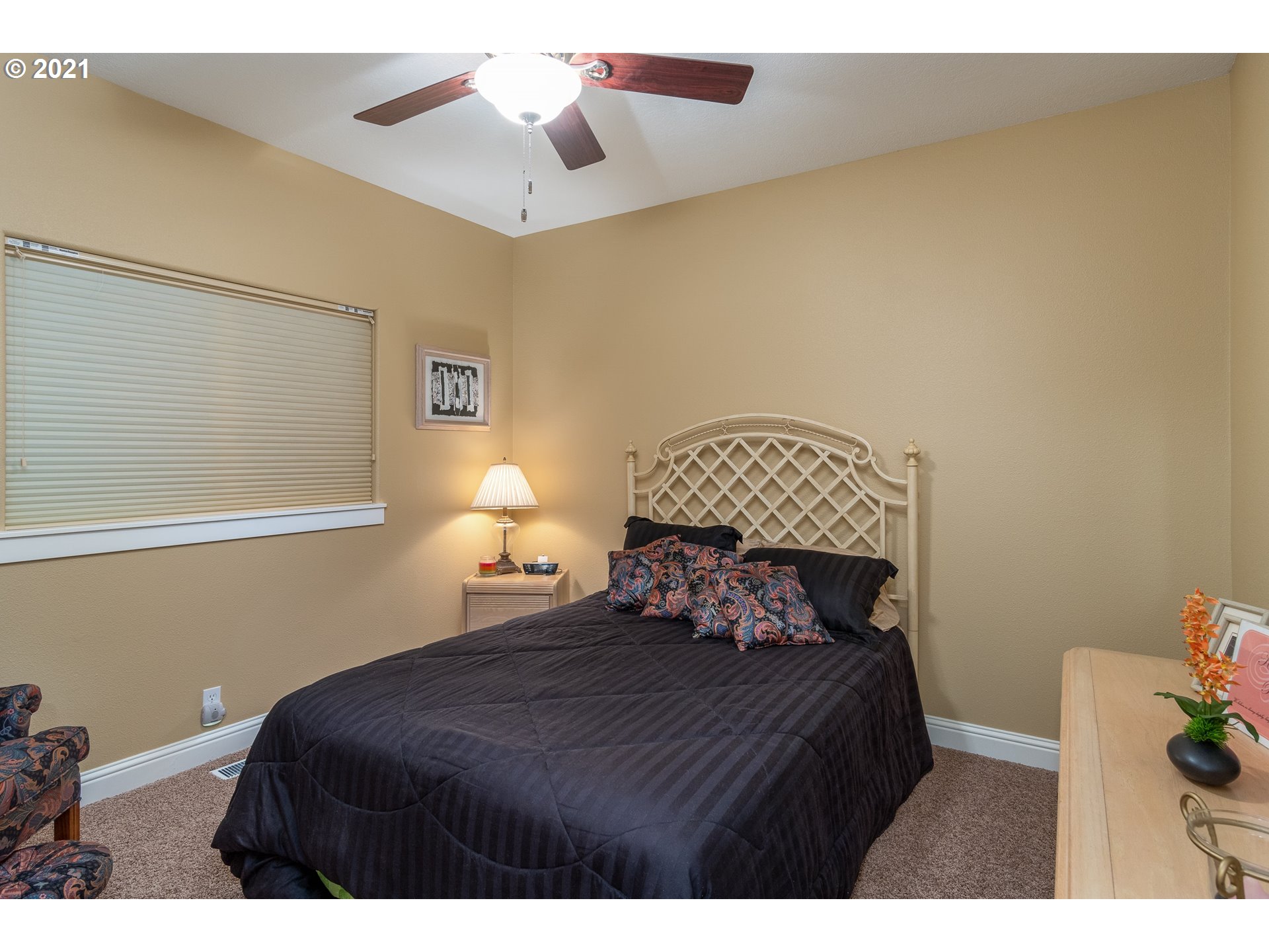 70946 Devore Arm Road Lakeside, OR 97449 - Photo 22 of 48 a bedroom with a bed and a chandelier