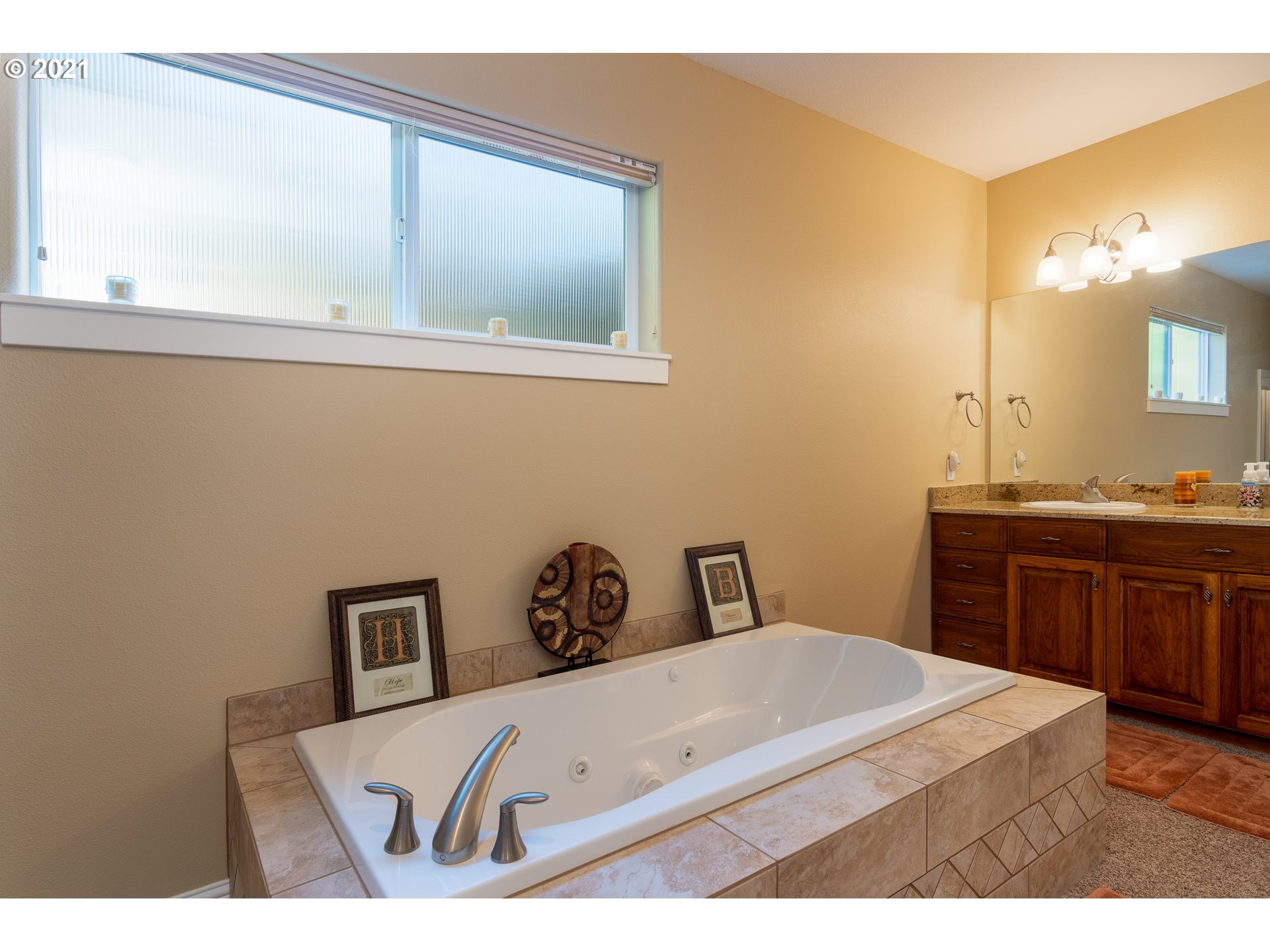 70946 Devore Arm Road Lakeside, OR 97449 - Photo 26 of 48 a bathroom with a sink a vanity and mirror