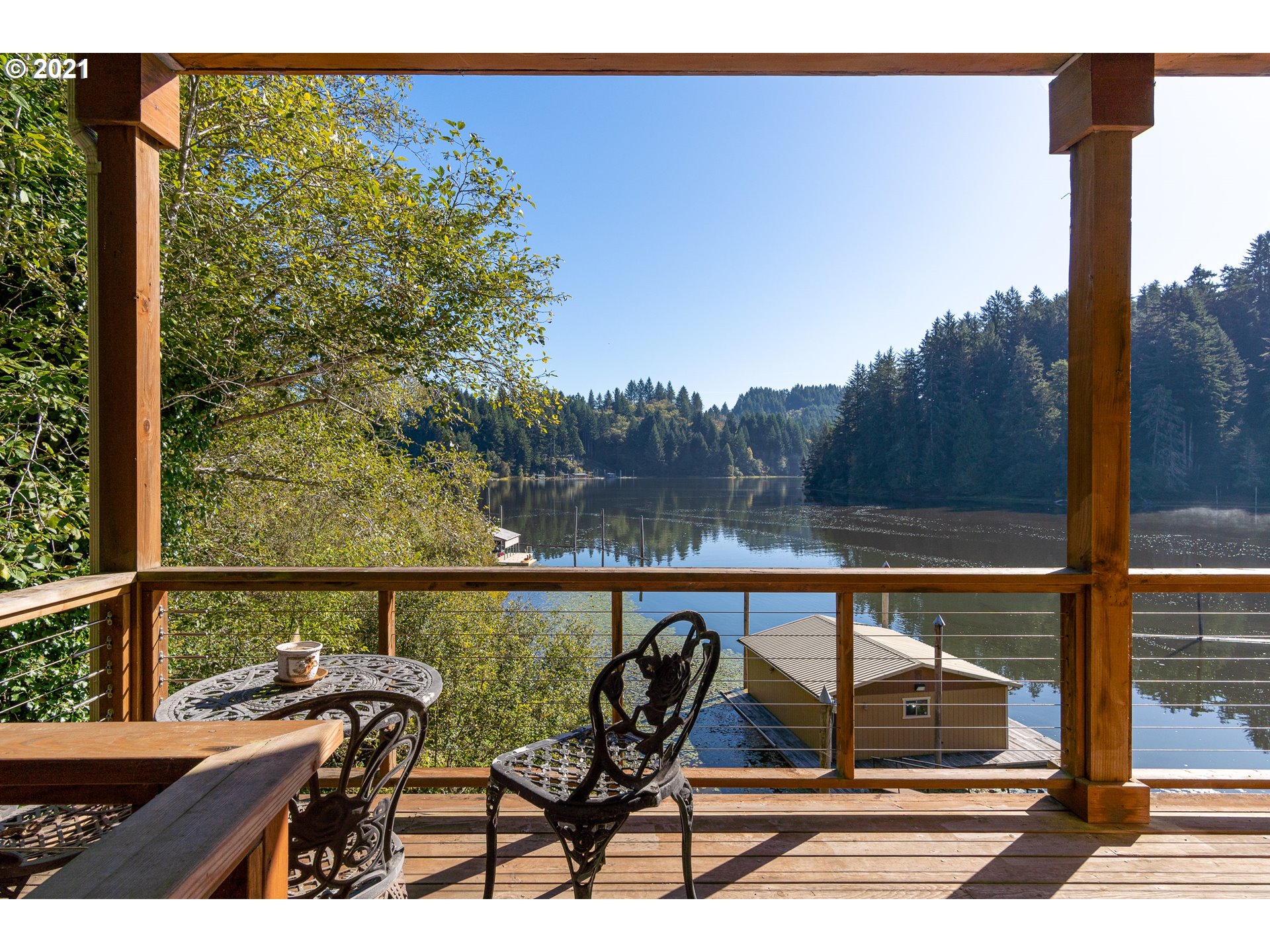 70946 Devore Arm Road Lakeside, OR 97449 - Photo 32 of 48 a view of a balcony with chairs and wooden floor