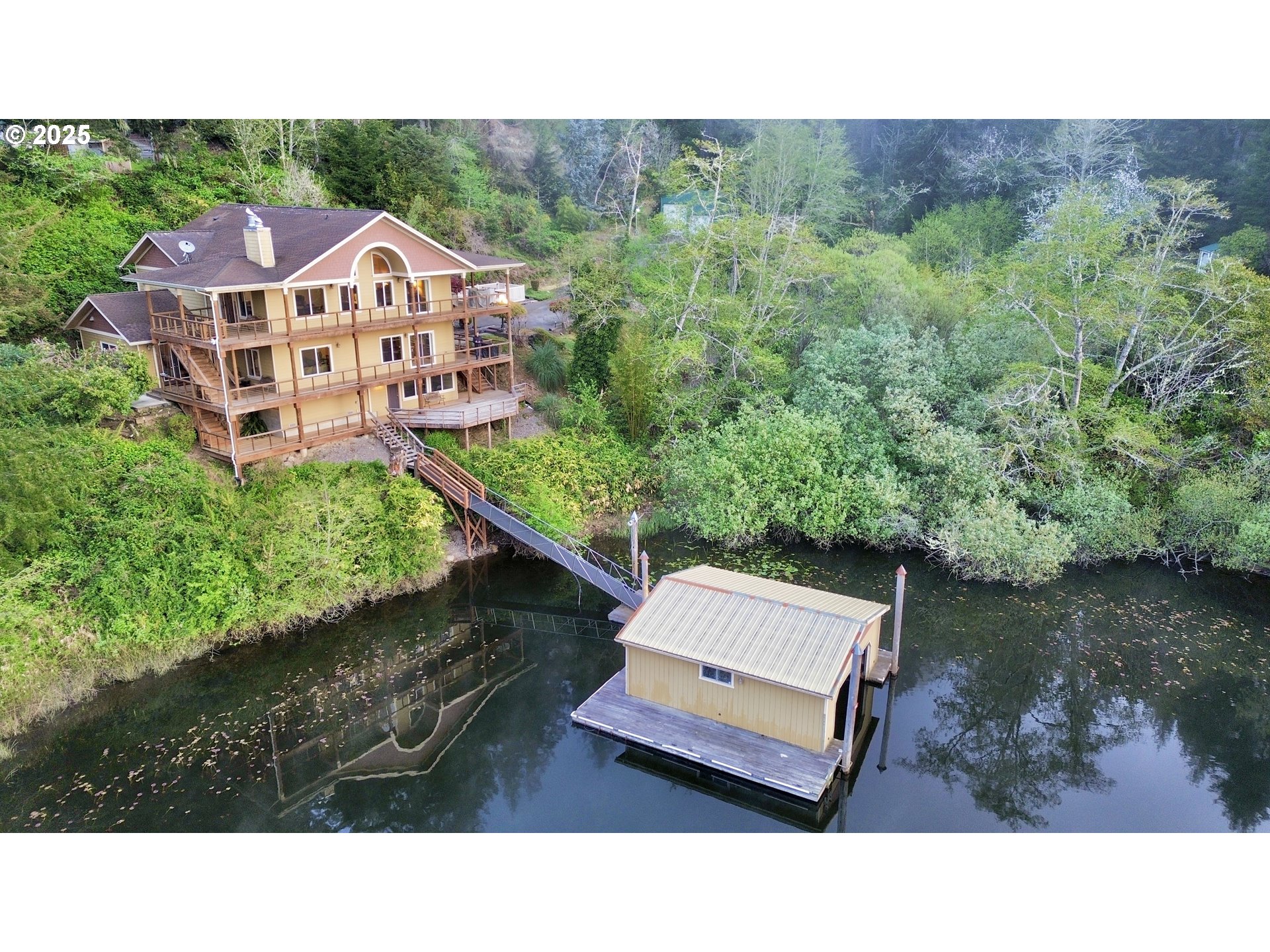 70946 Devore Arm Road Lakeside, OR 97449 - Photo 4 of 48 a aerial view of a house with a garden