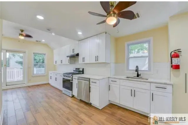 a kitchen with a sink window and cabinets