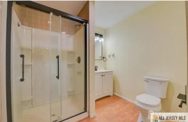 a bathroom with a toilet and a shower